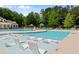 Community pool area boasts comfortable in-water seating and lounge chairs, perfect for relaxation and recreation at 138 Grand Ave, Suwanee, GA 30024
