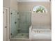 Shower with a glass surround and marble accents at 138 Grand Ave, Suwanee, GA 30024
