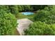 Outdoors sports courts surrounded by trees promote active living, including basketball and sand volleyball at 138 Grand Ave, Suwanee, GA 30024