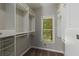 Spacious walk-in closet with built in shelving and storage, plus a natural light window at 138 Grand Ave, Suwanee, GA 30024