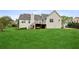 Expansive backyard featuring a deck, stairs, and swing set underneath providing entertainment and relaxation at 4940 Hanna Kate Ct, Cumming, GA 30028