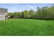 Sprawling backyard bordered by lush greenery and mature trees, enhances privacy and tranquility at 4940 Hanna Kate Ct, Cumming, GA 30028