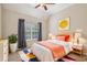 Bright bedroom featuring a ceiling fan, window, and colorful decor, offering a cozy and inviting space at 4940 Hanna Kate Ct, Cumming, GA 30028