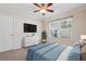Comfortable bedroom with a ceiling fan, large window, and TV for a relaxing and inviting space at 4940 Hanna Kate Ct, Cumming, GA 30028
