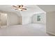 Large carpeted bonus room features a window and a door, offering plenty of space for activities at 4940 Hanna Kate Ct, Cumming, GA 30028
