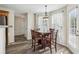 Cozy breakfast nook featuring wood floors, large windows, and elegant chandelier at 4940 Hanna Kate Ct, Cumming, GA 30028