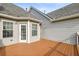 Outdoor deck featuring wooden flooring, accessible via a door, offering space for entertaining and relaxation at 4940 Hanna Kate Ct, Cumming, GA 30028