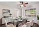 Dining room featuring glass table, white tufted chairs and modern sideboard at 4940 Hanna Kate Ct, Cumming, GA 30028