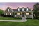 Charming two-story home with brick accents, manicured lawn, and inviting front porch at 4940 Hanna Kate Ct, Cumming, GA 30028