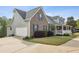 Charming two-story home boasts a brick facade, well-manicured lawn, and attached two car garage at 4940 Hanna Kate Ct, Cumming, GA 30028