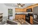 Kitchen features warm cabinets, black appliances, and sleek countertops at 4940 Hanna Kate Ct, Cumming, GA 30028