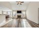 Bright living room with vaulted ceilings, a stone fireplace, and stylish hardwood floors at 4940 Hanna Kate Ct, Cumming, GA 30028