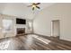 Spacious living room with a stone fireplace, hardwood floors, and an airy atmosphere at 4940 Hanna Kate Ct, Cumming, GA 30028
