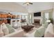 Inviting living room with stone fireplace open to kitchen and breakfast bar at 4940 Hanna Kate Ct, Cumming, GA 30028