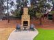 Outdoor fireplace with seating area and manicured landscape at 625 Piedmont Ne Ave # 2004, Atlanta, GA 30308