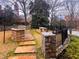 Outdoor grilling area with stone structure, seating, and manicured landscape at 625 Piedmont Ne Ave # 2004, Atlanta, GA 30308
