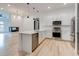 Bright kitchen with stainless steel appliances, white cabinets, and an island that opens to the living room at 625 Piedmont Ne Ave # 2004, Atlanta, GA 30308