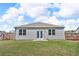 A fenced backyard with a grass lawn and patio doors provides a private outdoor space at 6920 Oak Valley Dr, Douglasville, GA 30134