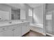 Modern bathroom featuring dual vanity, white cabinets, a soaking tub, and a glass-enclosed shower at 6920 Oak Valley Dr, Douglasville, GA 30134