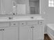Bathroom featuring double sink with white cabinets and large mirrors at 6920 Oak Valley Dr, Douglasville, GA 30134