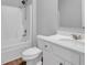 Clean bathroom featuring white fixtures, laminate floors, and a shower-tub combination at 6920 Oak Valley Dr, Douglasville, GA 30134