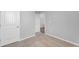 Neutral carpeted bedroom featuring paneled doors and white trim at 6920 Oak Valley Dr, Douglasville, GA 30134