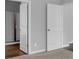 Hallway featuring white trim and baseboards plus an open door to the bathroom at 6920 Oak Valley Dr, Douglasville, GA 30134