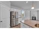 Bright kitchen featuring stainless steel appliances, a fireplace, and an island with granite countertops at 6920 Oak Valley Dr, Douglasville, GA 30134