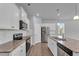 Modern kitchen featuring white cabinets, granite countertops, and stainless steel appliances at 6920 Oak Valley Dr, Douglasville, GA 30134