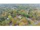 A high-angle aerial image of a house in a leafy neighborhood surrounded by green trees and houses at 753 Brookwood Sw Ter, Lilburn, GA 30047