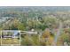 Aerial view of a home surrounded by lush trees in a neighborhood, showing both the house and nearby street at 753 Brookwood Sw Ter, Lilburn, GA 30047