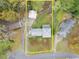 Property lines of an aerial view of a home with mature trees and a driveway leading to a detached garage at 753 Brookwood Sw Ter, Lilburn, GA 30047