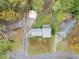 Aerial shot of a home featuring a well-maintained yard, mature trees, and a driveway leading to a detached garage at 753 Brookwood Sw Ter, Lilburn, GA 30047