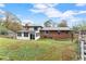 Expansive backyard featuring a well-maintained lawn and a view of the home's rear exterior, including a sunroom at 753 Brookwood Sw Ter, Lilburn, GA 30047