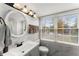 Bathroom with a granite counter, vanity and a window for natural lighting at 753 Brookwood Sw Ter, Lilburn, GA 30047