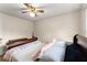 Bedroom with a ceiling fan, wood floors, and a window for natural lighting at 753 Brookwood Sw Ter, Lilburn, GA 30047