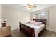 Bedroom with a ceiling fan, wood floors, and a window for natural lighting at 753 Brookwood Sw Ter, Lilburn, GA 30047