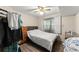 Bedroom with a ceiling fan, wood floors, and a window for natural lighting at 753 Brookwood Sw Ter, Lilburn, GA 30047