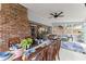 Inviting dining area with exposed brick wall and ample natural light, seamlessly connects to a cozy living space at 753 Brookwood Sw Ter, Lilburn, GA 30047
