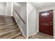 Entryway and stairs with stained wooden handrail and a decorative front door at 753 Brookwood Sw Ter, Lilburn, GA 30047