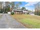 Two-story home featuring a well-maintained lawn, driveway and detached garages at 753 Brookwood Sw Ter, Lilburn, GA 30047