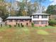 Charming split-level home featuring a well-maintained lawn and classic brick and siding design at 753 Brookwood Sw Ter, Lilburn, GA 30047