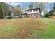 Well-maintained split-level home surrounded by mature trees and expansive lawn at 753 Brookwood Sw Ter, Lilburn, GA 30047