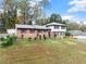 Two-story home featuring a well-maintained lawn, driveway and detached garages at 753 Brookwood Sw Ter, Lilburn, GA 30047