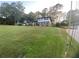 Large front lawn with two-story home featuring a brick facade and blue siding on the second level at 753 Brookwood Sw Ter, Lilburn, GA 30047
