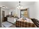 Charming eat-in kitchen features white cabinets, granite countertops, and a window view at 753 Brookwood Sw Ter, Lilburn, GA 30047