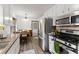Galley kitchen with stainless appliances and eat in space is bathed in natural light at 753 Brookwood Sw Ter, Lilburn, GA 30047