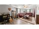 Spacious living room features hardwood flooring, comfortable leather sofas and ceiling fan at 753 Brookwood Sw Ter, Lilburn, GA 30047