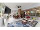 Bright living room featuring a TV, modern ceiling fan, and a comfortable sofa with large windows offering ample natural light at 753 Brookwood Sw Ter, Lilburn, GA 30047