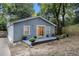 Exterior view of the rear of the house with siding and a small patio with shrubbery at 1812 Defoor Nw Ave, Atlanta, GA 30318
